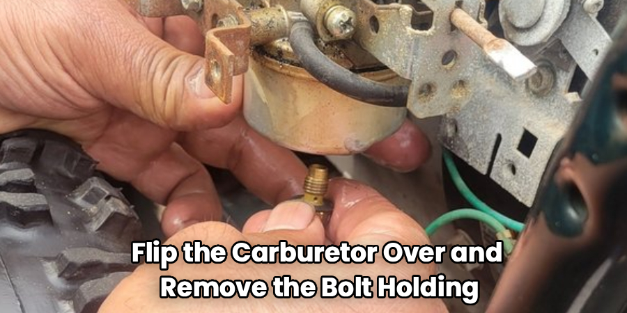 Flip the Carburetor Over and 
Remove the Bolt Holding