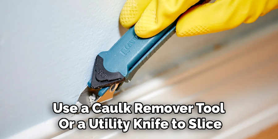 Use a Caulk Remover Tool 
Or a Utility Knife to Slice